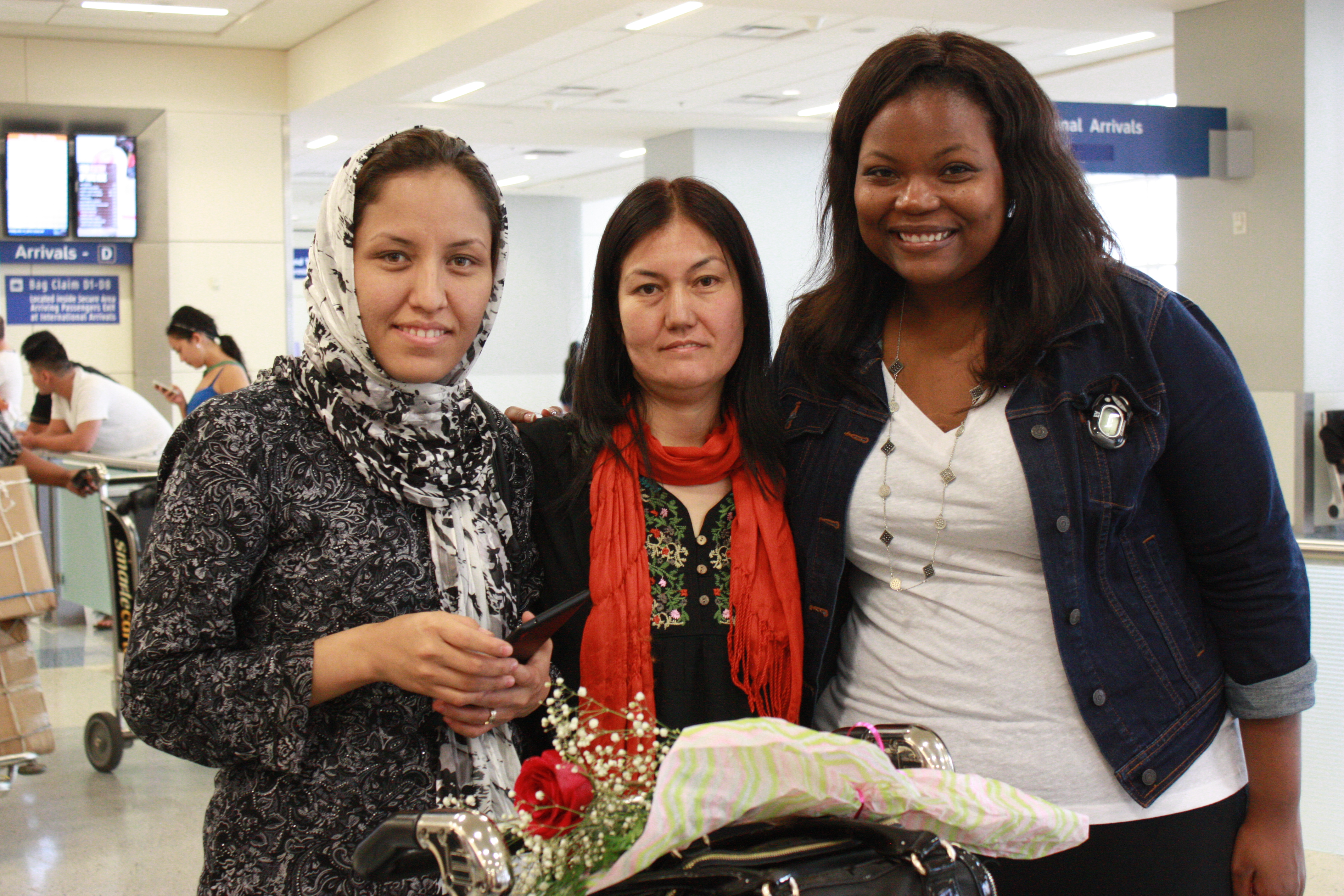 Hakima & Fakhria with an AT&T volunteer at DFW